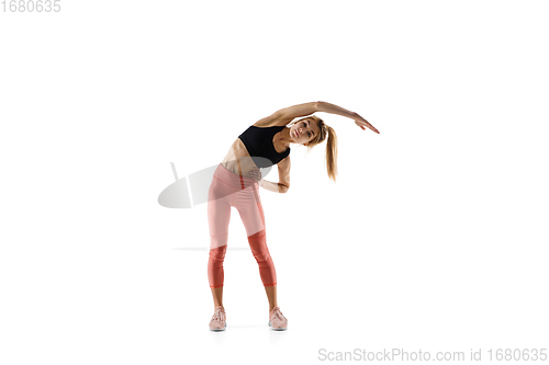 Image of Young caucasian female model in action, motion isolated on white background. Concept of sport, movement, energy and dynamic, healthy lifestyle. Training, practicing.