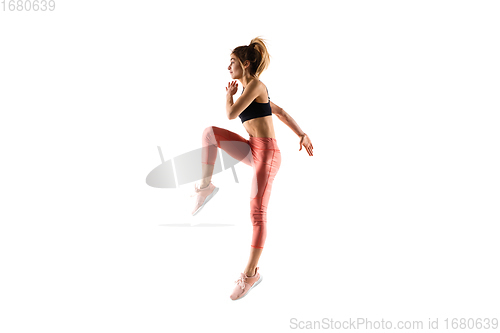 Image of Young caucasian female model in action, motion isolated on white background. Concept of sport, movement, energy and dynamic, healthy lifestyle. Training, practicing.