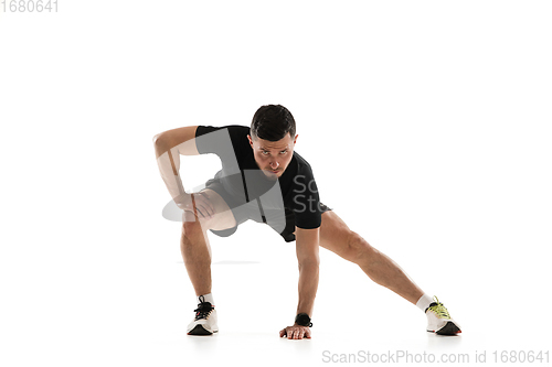 Image of Caucasian professional sportsman training isolated on white studio background. Muscular, sportive man practicing.