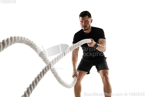 Image of Caucasian professional sportsman training isolated on white studio background. Muscular, sportive man practicing.