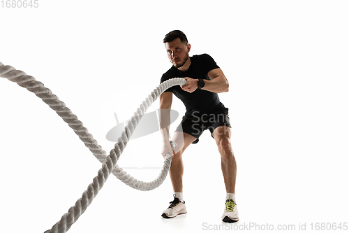 Image of Caucasian professional sportsman training isolated on white studio background. Muscular, sportive man practicing.