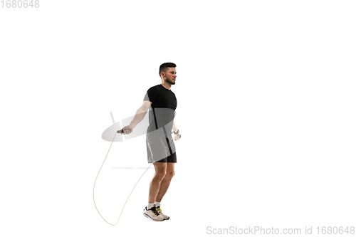 Image of Caucasian professional sportsman training isolated on white studio background. Muscular, sportive man practicing.