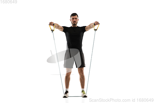 Image of Caucasian professional sportsman training isolated on white studio background. Muscular, sportive man practicing.