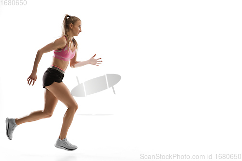 Image of Caucasian professional female runner, athlete training isolated on white studio background. Copyspace for ad.