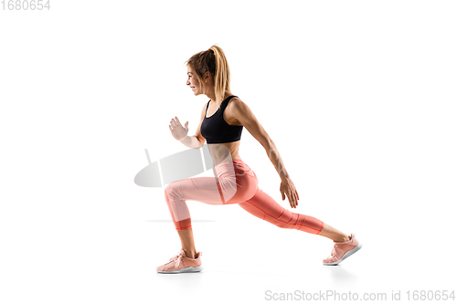 Image of Young caucasian female model in action, motion isolated on white background. Concept of sport, movement, energy and dynamic, healthy lifestyle. Training, practicing.