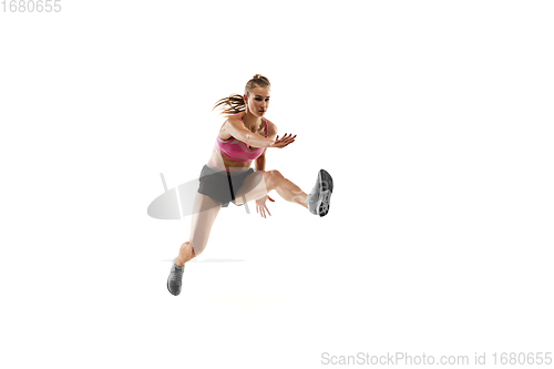 Image of Caucasian professional female runner, athlete training isolated on white studio background. Copyspace for ad.