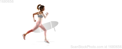 Image of Young caucasian female model in action, motion isolated on white background. Concept of sport, movement, energy and dynamic, healthy lifestyle. Training, practicing.