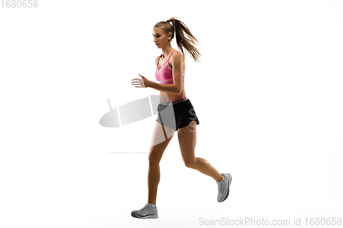 Image of Caucasian professional female runner, athlete training isolated on white studio background. Copyspace for ad.