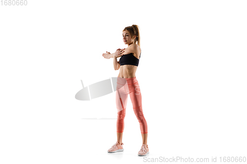 Image of Young caucasian female model in action, motion isolated on white background. Concept of sport, movement, energy and dynamic, healthy lifestyle. Training, practicing.