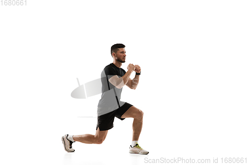 Image of Caucasian professional sportsman training isolated on white studio background. Muscular, sportive man practicing.