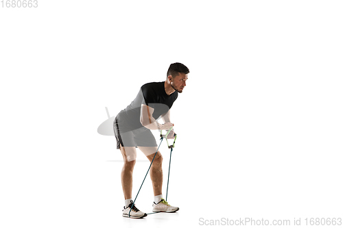 Image of Caucasian professional sportsman training isolated on white studio background. Muscular, sportive man practicing.