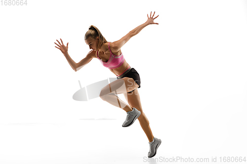 Image of Caucasian professional female runner, athlete training isolated on white studio background. Copyspace for ad.