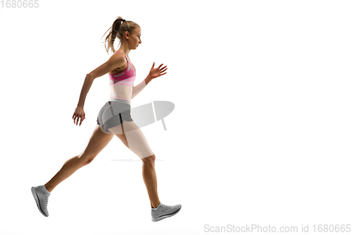 Image of Caucasian professional female runner, athlete training isolated on white studio background. Copyspace for ad.