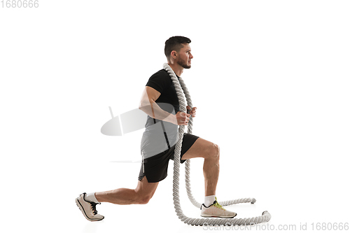 Image of Caucasian professional sportsman training isolated on white studio background. Muscular, sportive man practicing.