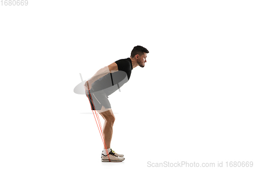 Image of Caucasian professional sportsman training isolated on white studio background. Muscular, sportive man practicing.