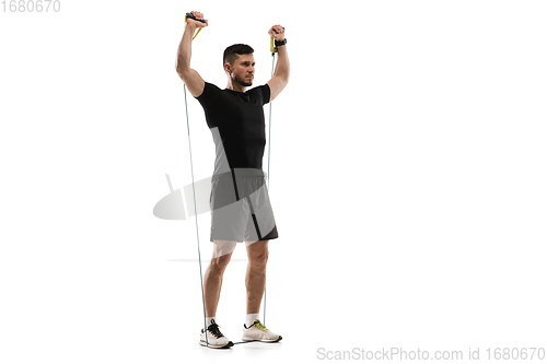 Image of Caucasian professional sportsman training isolated on white studio background. Muscular, sportive man practicing.