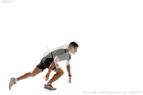 Image of Caucasian professional sportsman training isolated on white studio background. Muscular, sportive man practicing.