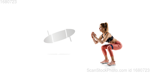 Image of Young caucasian female model in action, motion isolated on white background. Concept of sport, movement, energy and dynamic, healthy lifestyle. Training, practicing.