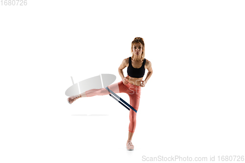 Image of Young caucasian female model in action, motion isolated on white background. Concept of sport, movement, energy and dynamic, healthy lifestyle. Training, practicing.