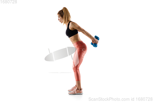 Image of Young caucasian female model in action, motion isolated on white background. Concept of sport, movement, energy and dynamic, healthy lifestyle. Training, practicing.