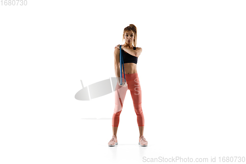 Image of Young caucasian female model in action, motion isolated on white background. Concept of sport, movement, energy and dynamic, healthy lifestyle. Training, practicing.