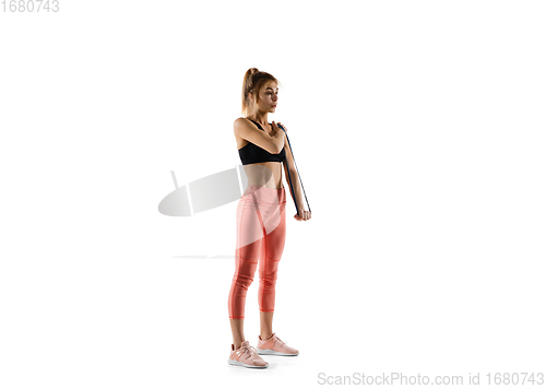 Image of Young caucasian female model in action, motion isolated on white background. Concept of sport, movement, energy and dynamic, healthy lifestyle. Training, practicing.