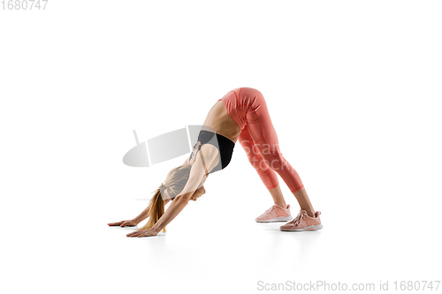 Image of Young caucasian female model in action, motion isolated on white background. Concept of sport, movement, energy and dynamic, healthy lifestyle. Training, practicing.