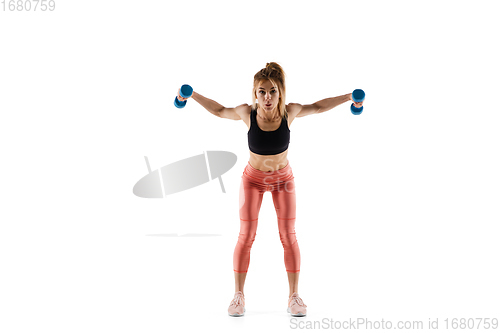 Image of Young caucasian female model in action, motion isolated on white background. Concept of sport, movement, energy and dynamic, healthy lifestyle. Training, practicing.