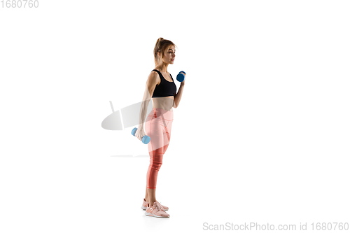 Image of Young caucasian female model in action, motion isolated on white background. Concept of sport, movement, energy and dynamic, healthy lifestyle. Training, practicing.