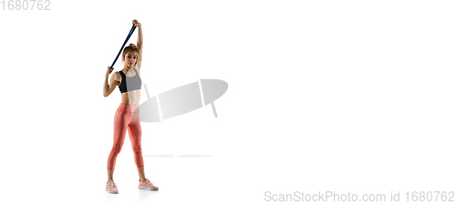 Image of Young caucasian female model in action, motion isolated on white background. Concept of sport, movement, energy and dynamic, healthy lifestyle. Training, practicing.