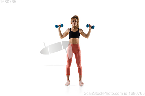 Image of Young caucasian female model in action, motion isolated on white background. Concept of sport, movement, energy and dynamic, healthy lifestyle. Training, practicing.