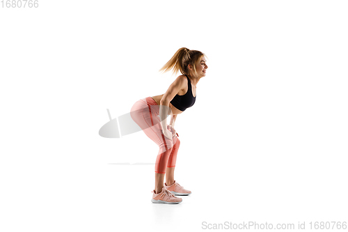 Image of Young caucasian female model in action, motion isolated on white background. Concept of sport, movement, energy and dynamic, healthy lifestyle. Training, practicing.