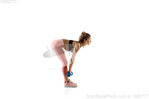 Image of Young caucasian female model in action, motion isolated on white background. Concept of sport, movement, energy and dynamic, healthy lifestyle. Training, practicing.