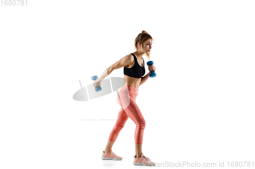 Image of Young caucasian female model in action, motion isolated on white background. Concept of sport, movement, energy and dynamic, healthy lifestyle. Training, practicing.