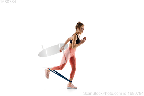 Image of Young caucasian female model in action, motion isolated on white background. Concept of sport, movement, energy and dynamic, healthy lifestyle. Training, practicing.