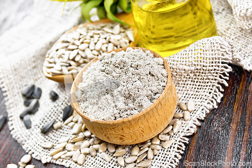 Image of Flour sunflower in bowl with oil on wooden board