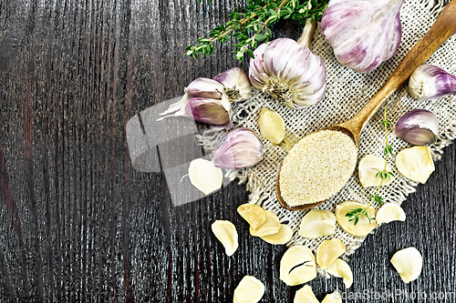 Image of Garlic ground in spoon on board top