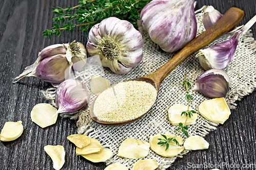 Image of Garlic ground in spoon on burlap