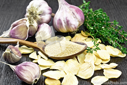 Image of Garlic ground in spoon on dark board