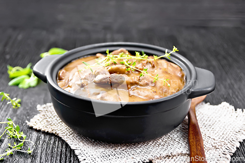 Image of Goulash of beef in pan on black board