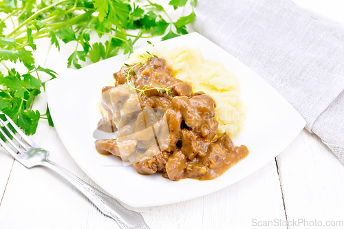 Image of Goulash of beef with mashed potatoes in plate on white board
