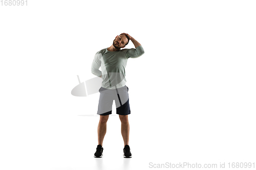 Image of Young caucasian male model in action, motion isolated on white background. Concept of sport, movement, energy and dynamic, healthy lifestyle. Training, practicing.