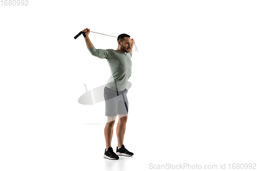 Image of Young caucasian male model in action, motion isolated on white background. Concept of sport, movement, energy and dynamic, healthy lifestyle. Training, practicing.