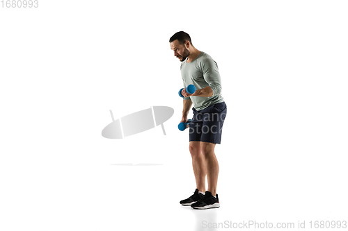 Image of Young caucasian male model in action, motion isolated on white background. Concept of sport, movement, energy and dynamic, healthy lifestyle. Training, practicing.