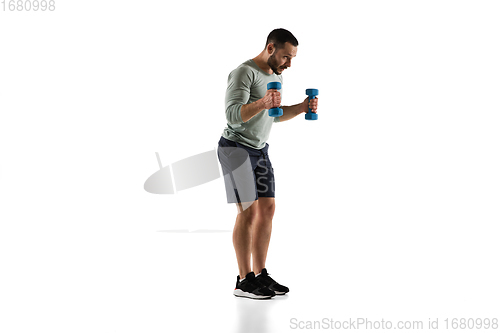 Image of Young caucasian male model in action, motion isolated on white background. Concept of sport, movement, energy and dynamic, healthy lifestyle. Training, practicing.