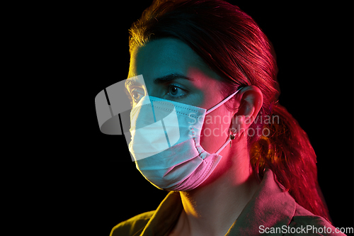 Image of young woman wearing protective medical mask