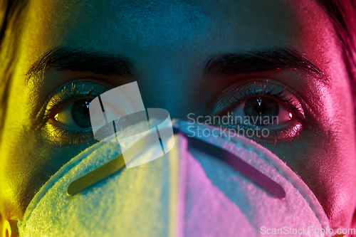 Image of young woman wearing protective mask or respirator