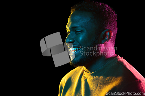 Image of young african american man over black background