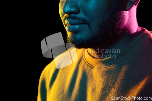 Image of young african american man over black background