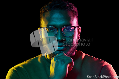 Image of young african american man in glasses over black